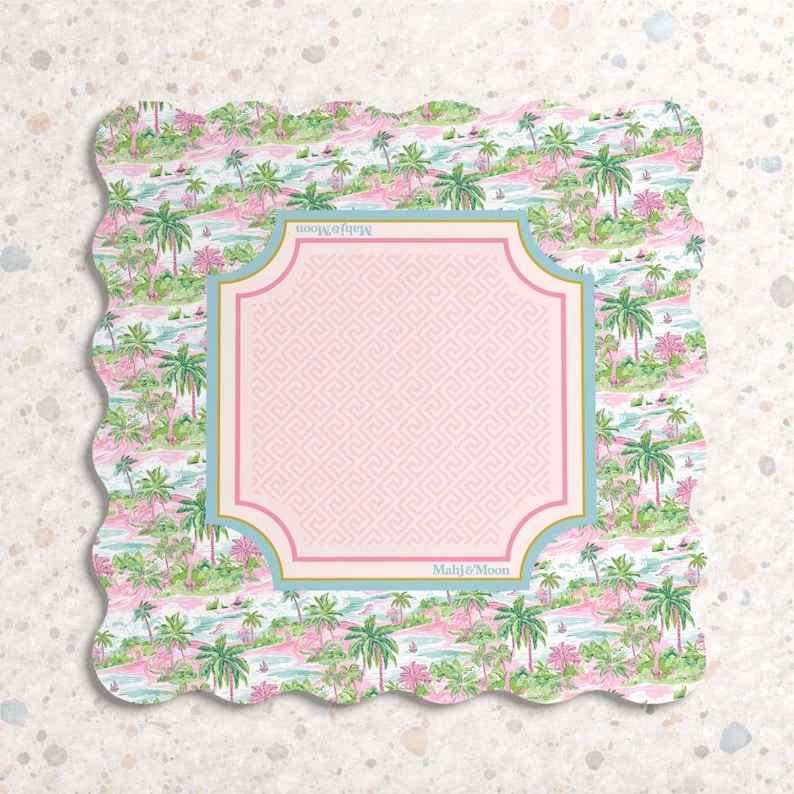 May include: A square scalloped-edge coaster featuring a tropical pattern of green palm trees and pink foliage on a light background. A central light pink square with a Greek key border and gold trim displays the text Mahj&Moon at the top and bottom.