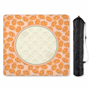 May include: A rectangular, pumpkin-themed picnic blanket with a repeating pattern of orange pumpkins on a light pink background. The center features a circular design with pumpkin outlines and the text "MAHU & MOON". A black carrying bag is included.