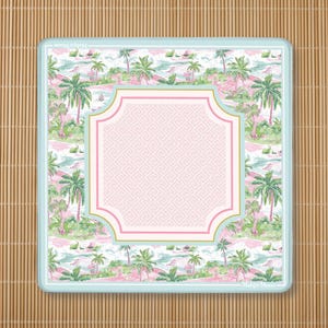 May include: A square coaster with a light blue border featuring a tropical pattern of green palm trees and pink landscapes. In the center, a quatrefoil-shaped frame with a pink Greek key pattern and gold trim. The text Mahj & Moon is visible.