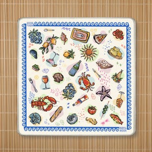 May include: A square off-white textile mat featuring a blue Greek key border and the text MAHJ & MOON. The surface is decorated with colorful illustrations of seafood, fruit, vegetables, wine glasses, a sun, and various shells in a scattered pattern.