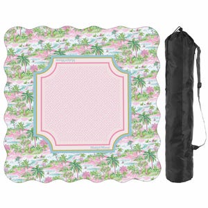 May include: A square mat with scalloped edges featuring a pink and green tropical palm tree pattern and a central light pink square with a Greek key border. The text Mahj&Moon is printed on the border. A black cylindrical carrying bag is included.