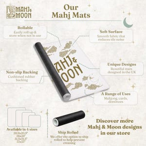 May include: A white Mahj & Moon game mat with gold cloud and moon graphics, featuring a black non-slip rubber backing. The mat is rollable and shown in a partially rolled state. Text includes "Our Mahj Mats" and "Mahj & Moon" with size options listed as 20.9x20.9, 26x26, 31.5x31.5, and 33x33 inches.