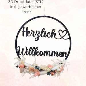 Może przedstawiać: Czarny drewniany znak z napisem "Herzlich Willkommen" i sercem, wiszący na wianku z suszonych kwiatów.