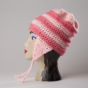 May include: Pink and light pink striped crocheted hat with ear flaps and a long tie.