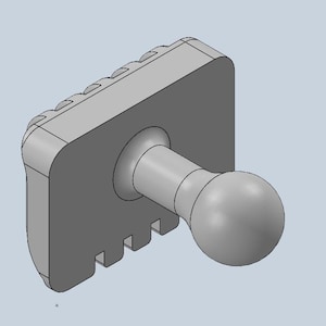 May include: A grey plastic ball joint with a rectangular base and a series of ridges on the side. The ball joint is designed to be used with a variety of accessories.