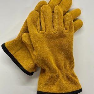 May include: A pair of yellow leather work gloves with black stitching around the wrist.
