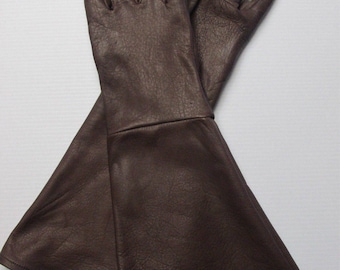 May include: A pair of dark brown leather gloves with long gauntlets. The gloves have a textured surface and are designed to cover the hands and wrists. The date "07/30/2016" is printed on the left gauntlet. These gloves are suitable for costume or historical reenactment.