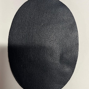 May include: A black leather circle, possibly a patch or a coaster.