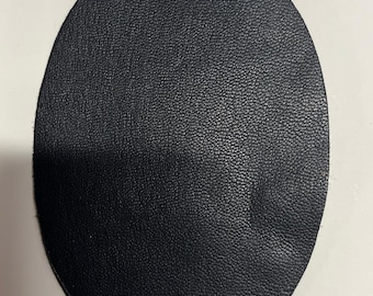 May include: A black leather circle, possibly a patch or a coaster.