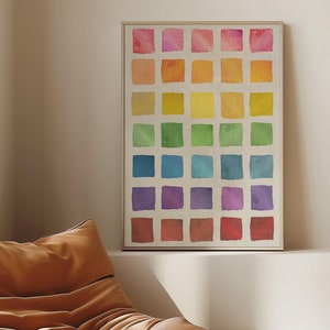 Może przedstawiać: Brązowy skórzany fotel z nadrukiem akwarelowym tęczy wiszącym na ścianie nad nim. Lampa z białym abażurem i stos książek znajdują się na białej półce pod nadrukiem.