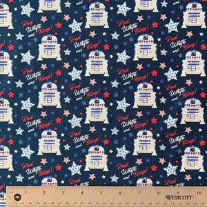 May include: Dark blue fabric with a repeating pattern of white and blue droids, red and white stars, and the text "Red, White, and Bloop!". The design is reminiscent of a patriotic theme, suitable for crafting or apparel.