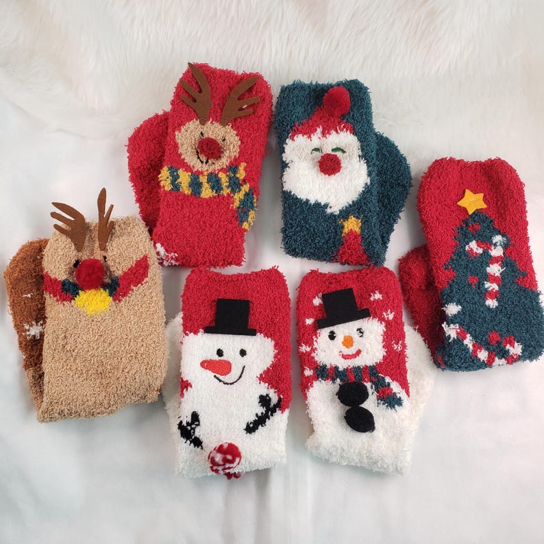May include: Six pairs of fuzzy Christmas-themed socks. The socks feature a reindeer, Santa Claus, a snowman, and a Christmas tree.