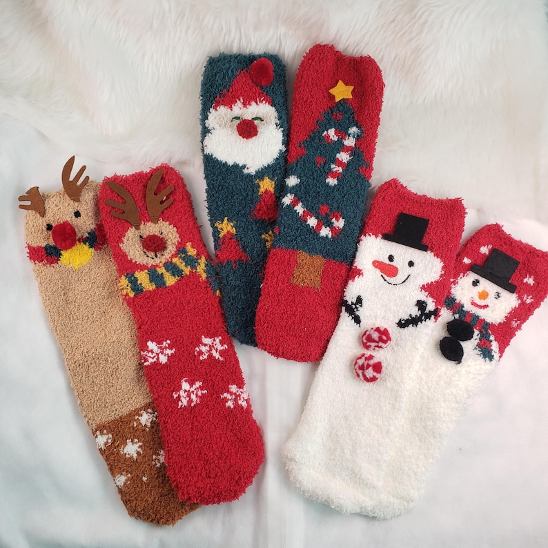 May include: Five pairs of fuzzy Christmas-themed socks. The socks feature a snowman, reindeer, Santa Claus, and a Christmas tree.