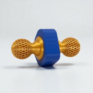 May include: A door knob with a gold finish and a blue center. The knob has a spherical, lattice-like design on each end. The blue center has the text "MOCK DOOR 40MM".