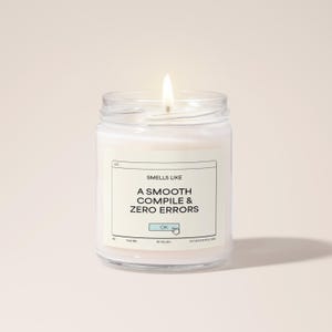 May include: A white candle in a glass jar with a label that reads "Smells Like A Smooth Compile & Zero Errors" with an "OK" button graphic.