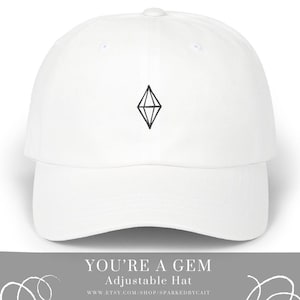 May include: White adjustable baseball cap with a black diamond graphic and the text "YOU'RE A GEM" on the front.