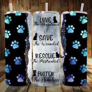 Könnte beinhalten: Drei Edelstahlbecher mit einem schwarzen und blauen Pfotenabdruck-Design. Der mittlere Becher hat einen weißen Hintergrund mit dem Text "Love the Abandoned, Save the Wounded, Rescue the Mistreated, Foster the Homeless".