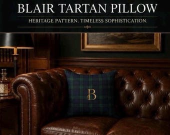 May include: A square throw pillow featuring a dark green and navy blue tartan plaid pattern with a gold embroidered letter B in the center. The text BLAIR TARTAN PILLOW and HERITAGE PATTERN. TIMELESS SOPHISTICATION. is printed above the pillow.