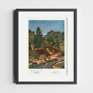 May include: A vintage Japanese woodblock print depicting a village nestled in a lush green valley. The print features a stream, a bridge, and several traditional Japanese houses with thatched roofs. The text in the image reads "A Corner of the Village, Near the Buddhist Temple of the Old Way, by the River, in the Town of Takayama."
