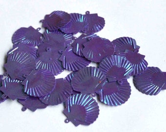 May include: A pile of purple iridescent plastic seashells with a scalloped edge. The shells have a shiny finish and are perfect for crafting projects.