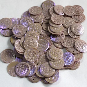 May include: A pile of iridescent brown round plastic sequins with a geometric design. The sequins have two holes for sewing.