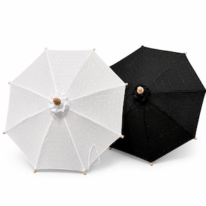 black and white floral patio umbrella Hawaiian Quilt Print Foldable Green Monstera/Forest Canopy while its frame is made using a combination of sturdy aluminum and zinc plated steel and features a tilt Floral Patio Umbrellas | Vintage