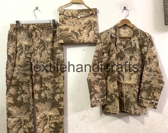 May include: A matching pajama set with a floral pattern in shades of brown and beige. The set includes pants, a button-down shirt, and a small pouch. The text "textilehandicrafts" is visible.