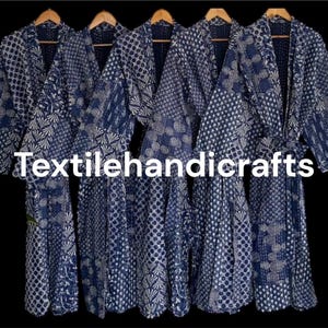 May include: Five blue and white patterned robes hanging on wooden hangers. The robes feature a patchwork design with various geometric and floral patterns. The text "Textilehandicrafts" is visible in white across the image.