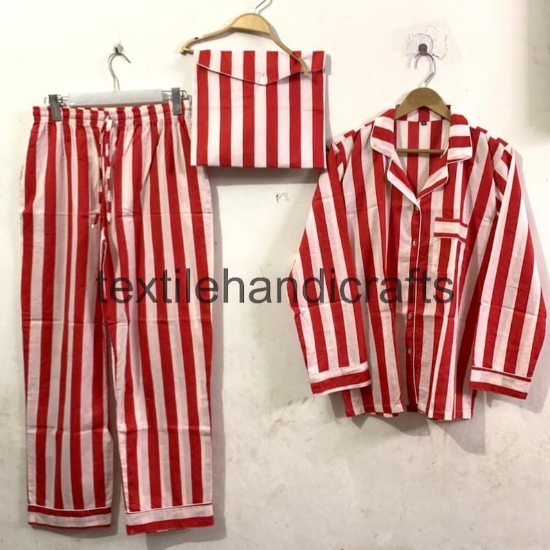 May include: A red and white striped pajama set, including pants, a button-down shirt, and a matching pouch. The set is displayed on hangers against a plain background. The text "textilehandicrafts" is visible.