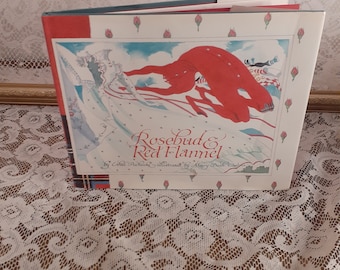 May include: A children's book titled "Rosebud & Red Flannel" by Ethel Pochocki, illustrated by Mary Beth Owens. The cover features a red figure with a white dress and a red figure with a red dress.