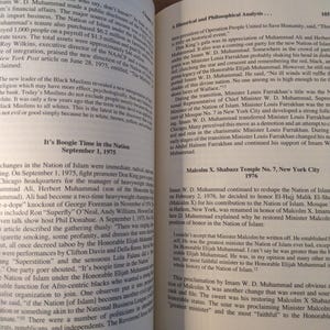 May include: Open book with text on the pages. The text includes the title "It's Boogie Time in the Nation" and "Malcolm X. Shabazz Temple No. 7, New York City 1976". The pages are yellowed.