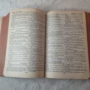 May include: Open book with aged, yellowed pages. The text is from Shakespeare's Romeo and Juliet. The book has a worn, reddish-brown cover and is open to a double-page spread.