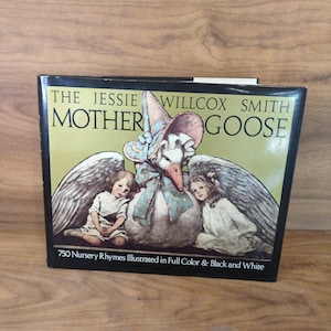 May include: A hardcover book titled The Jessie Willcox Smith Mother Goose featuring an illustration of a large goose wearing a bonnet between two children with wings. The cover text reads 750 Nursery Rhymes Illustrated in Full Color & Black and White.