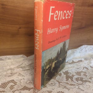 May include: Vintage hardcover book titled "Fences" by Harry Symons. The book has a red cover with white lettering and a landscape illustration. The spine is orange with the title and author's name.