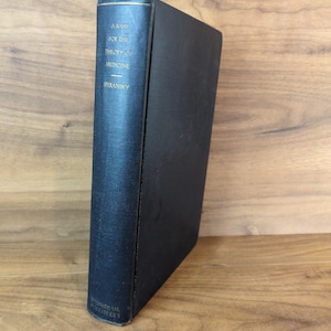 May include: A Basis for the Theory of Medicine by Speransky, a hardcover book with a dark blue cover and gold lettering. The book is standing upright on a wooden surface. The publisher's name is visible at the bottom of the spine.