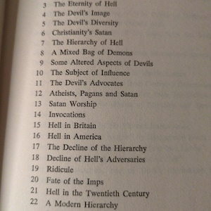 May include: A book's contents page, listing topics about hell such as "The Devil's Image," "Satan Worship," and "Hell in America." The text is in black on a cream-coloured page.