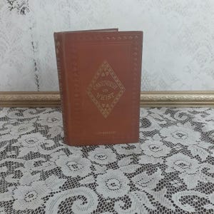 May include: A brown leather-bound book with gold lettering on the cover. The title is "Cavendish on Whist" and the book is a 12th edition.