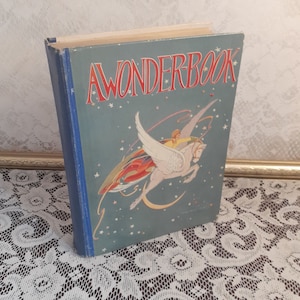 May include: A vintage blue and white hardcover book titled "A Wonder Book" with a colorful illustration of a winged horse flying through the night sky with a person riding on its back.