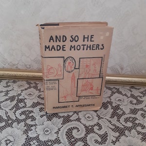 May include: A vintage book titled "And So He Made Mothers" by Margaret T. Applegarth. The cover features illustrations of people and scenes in black and white.