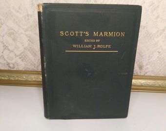 May include: A vintage hardcover book titled "Scott's Marmion" edited by William J. Rolfe. The book has a dark green cover with gold lettering. The book is standing upright on a white surface.