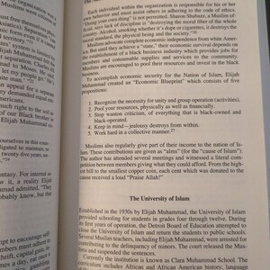 May include: Open book with text about The Nation of Islam, 1930-1959, and The University of Islam. The text discusses economic independence, community, and the educational institution's history. The page numbers are visible.