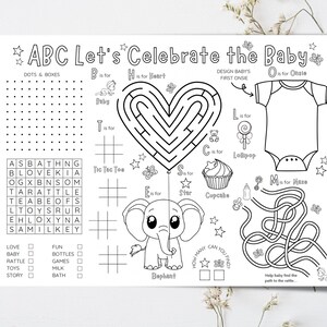 May include: Black and white baby-themed activity sheet with the text "ABC Let's Celebrate the Baby." Features include a heart-shaped maze, an elephant illustration, a word search, and a onesie outline. Includes the words "Baby", "Lollipop", and "Cupcake".