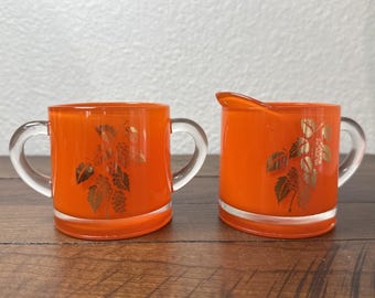 Retro Bartlett Collins koraalkleurige glazen creamer en suikerpot met bladgoud jaren 50