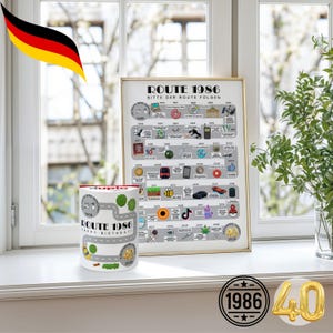 May include: A framed print and a mug with a road map design. The print reads "ROUTE 1986" with a timeline of events. The mug says "ROUTE 1986 HAPPY BIRTHDAY!" and features a road design. A gold "40" is also visible.