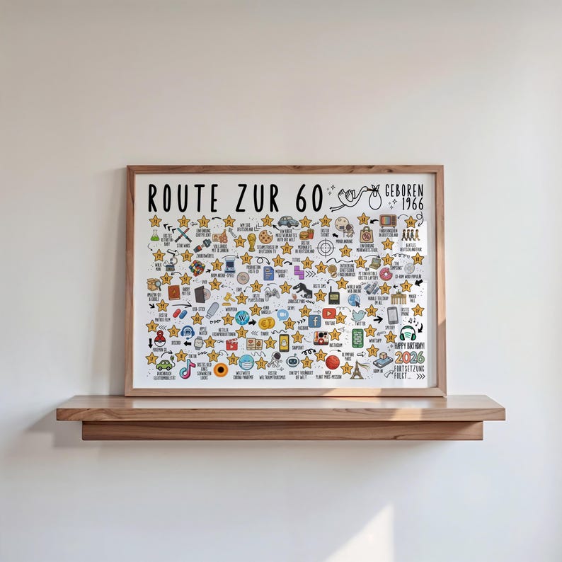 May include: A framed print with the text "ROUTE ZUR 60" and "GEBOREN 1966". The print is filled with small illustrations and star shapes. It is displayed on a wooden shelf against a white wall.