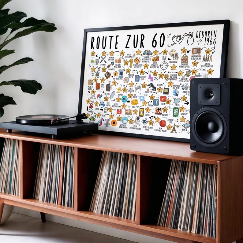 May include: A wooden record cabinet with a black turntable and speaker. A framed print with the text "ROUTE ZUR 60" and "GEBOREN 1966" is displayed. The print features various icons and star-shaped illustrations.