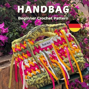 May include: A handmade crochet handbag with a beginner pattern. The bag features a mix of green, pink, yellow, and white yarn, with long fringe accents. The text "HANDBAG" and "Beginner Crochet Pattern" are displayed on the image.
