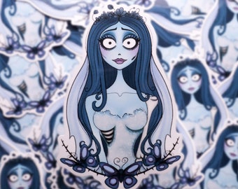 May include: A collection of stickers featuring a blue-skinned bride with long blue hair, a white veil, and a white dress. The bride has large, expressive eyes and is surrounded by butterfly and floral accents.