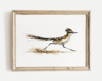 May include: Watercolor painting of a roadrunner in motion, framed in a rustic wooden frame. The bird is depicted with brown and tan hues, with a long tail and spiky crest. The artwork captures the roadrunner's speed and energy.