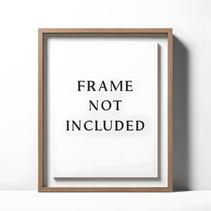 May include: A rectangular wooden picture frame with a white interior. The text "FRAME NOT INCLUDED" is centered on the white background in a bold, black font. The frame has a natural wood grain finish.